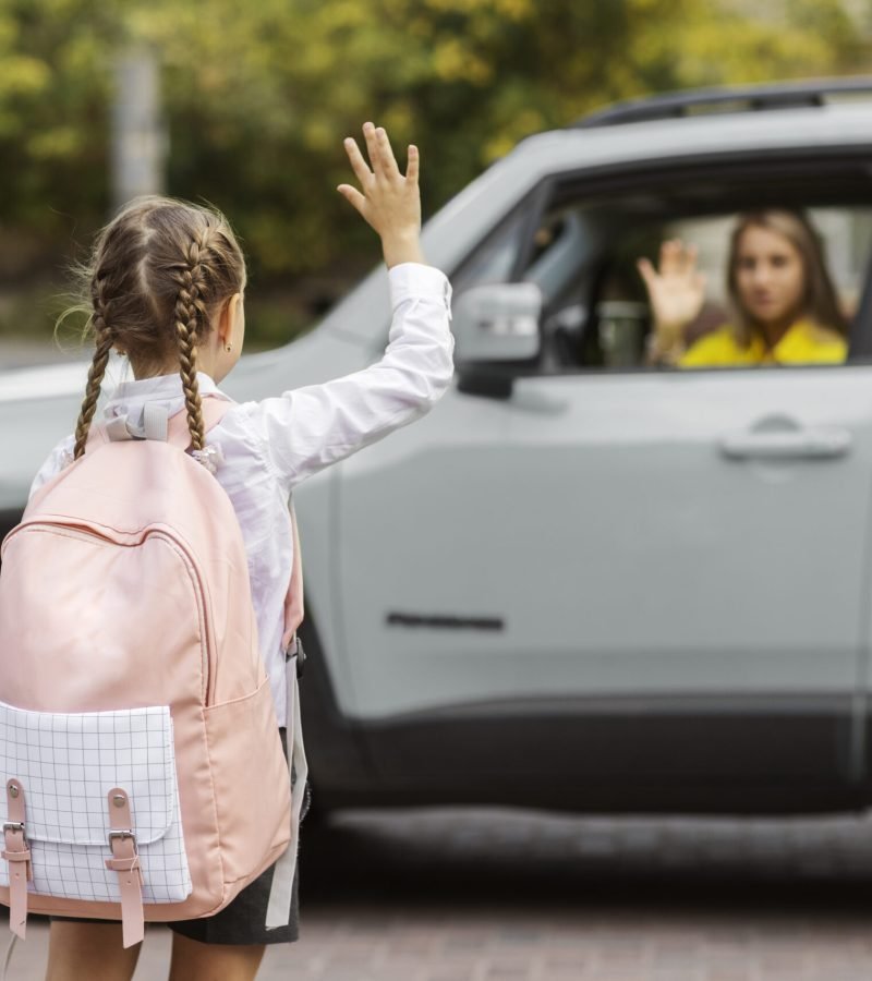 back-view-girl-waving-mother