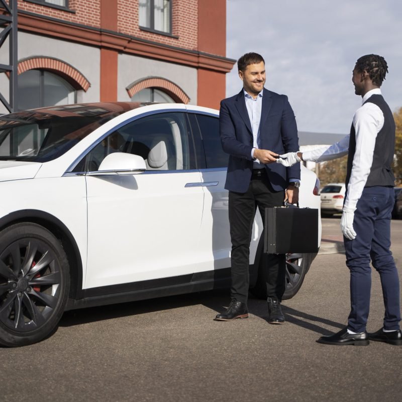 full-shot-man-valet-holding-key