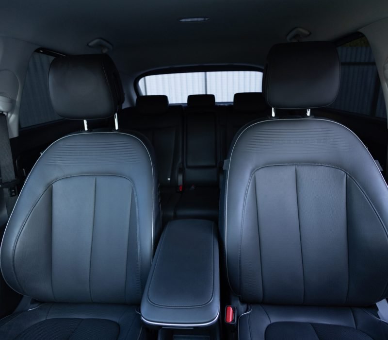 Luxury car leather seats. Interior of new modern clean expensive car. Passenger seats with leather. Closeup details. New car inside. Car cleaning theme.