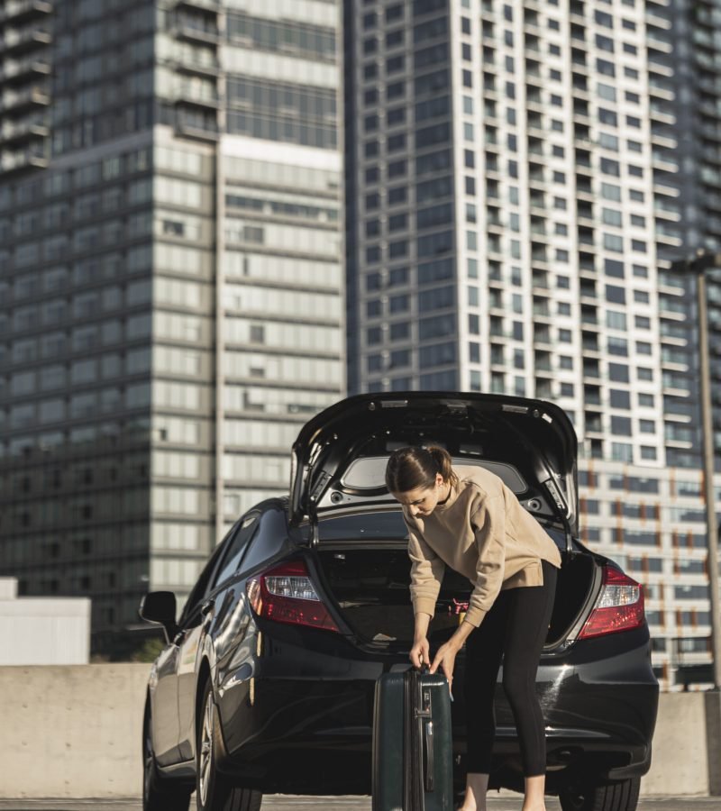 young-woman-with-car-suitcase